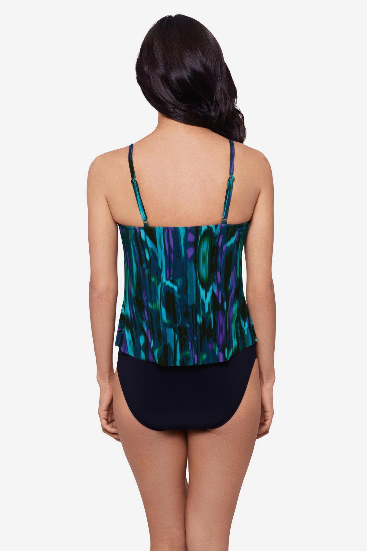 Woman turned away wearing a blue and green pattern tankini top