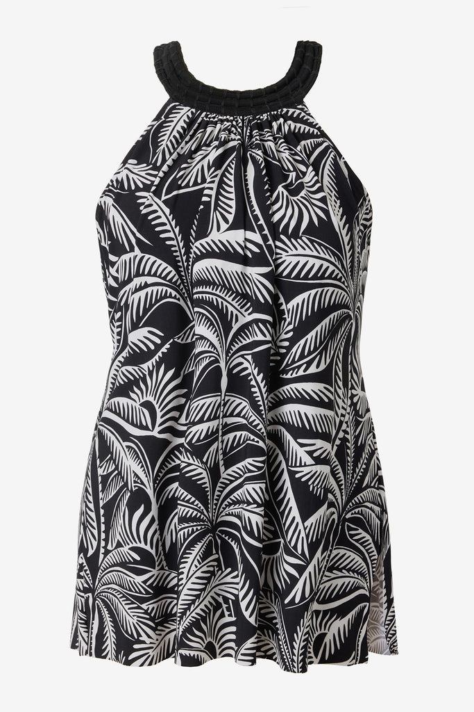 Woman wearing a black and white palm leaf printed swim dress 