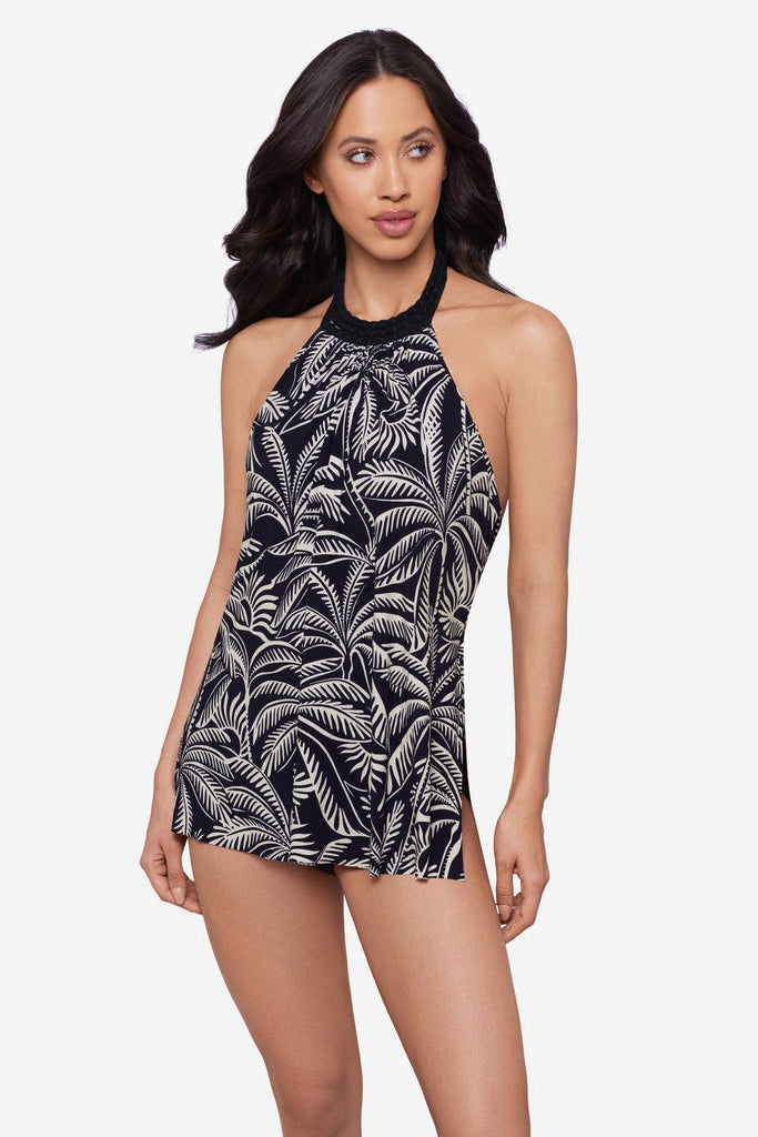 Woman wearing a black and white palm leaf printed swim dress