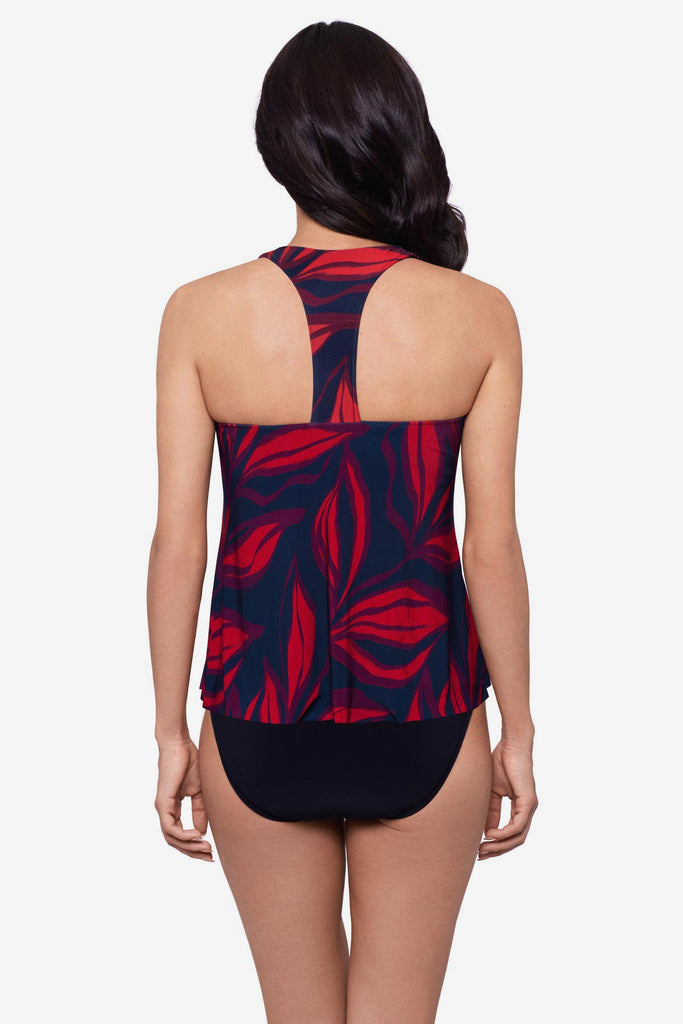 Woman turned away wearing a red leaf print tankini top