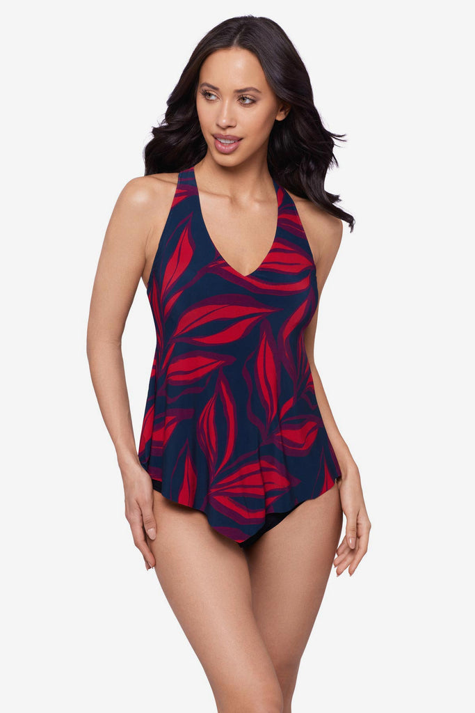 Woman wearing a red leaf print tankini top