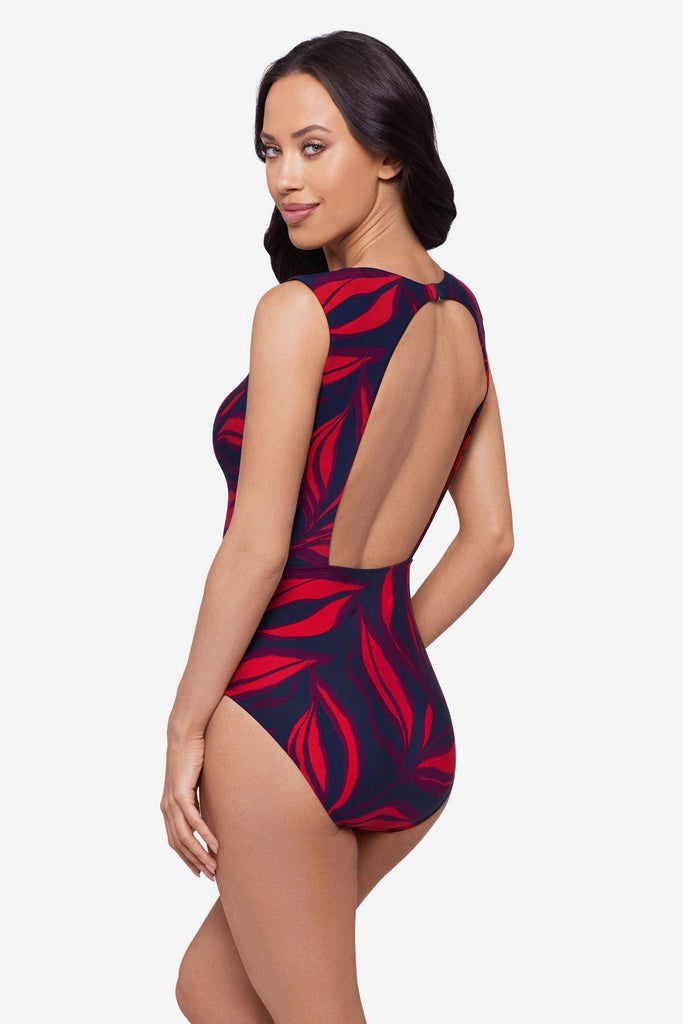 Woman turned right wearing a red leaf printed one-piece swimsuit with short sleeves
