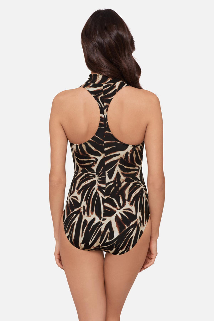 Woman turned away wearing an abstract printed one-piece swimsuit 