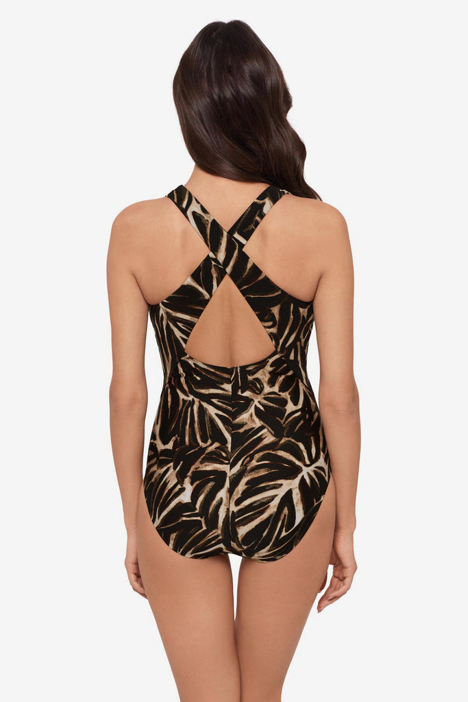 Woman faced away wearing a brown leaf printed one-piece