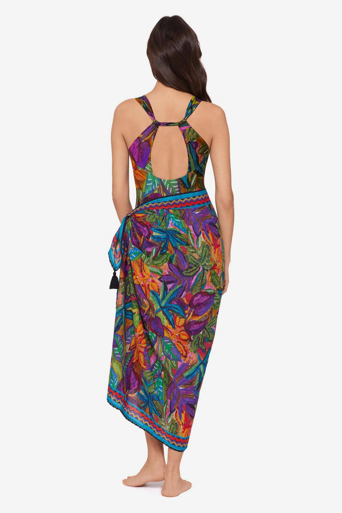 Woman turned away wearing a jungle printed one-piece swimsuit with a matching swim cover up