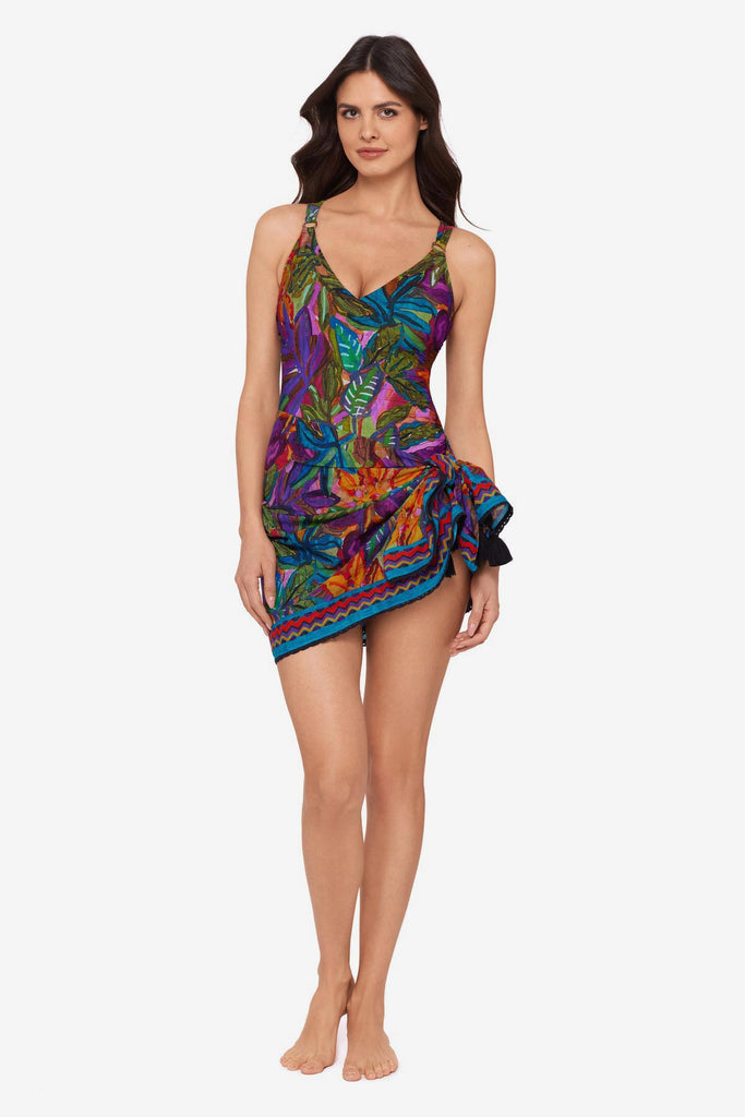 Woman wearing a jungle printed one-piece swimsuit with a matching swim cover up