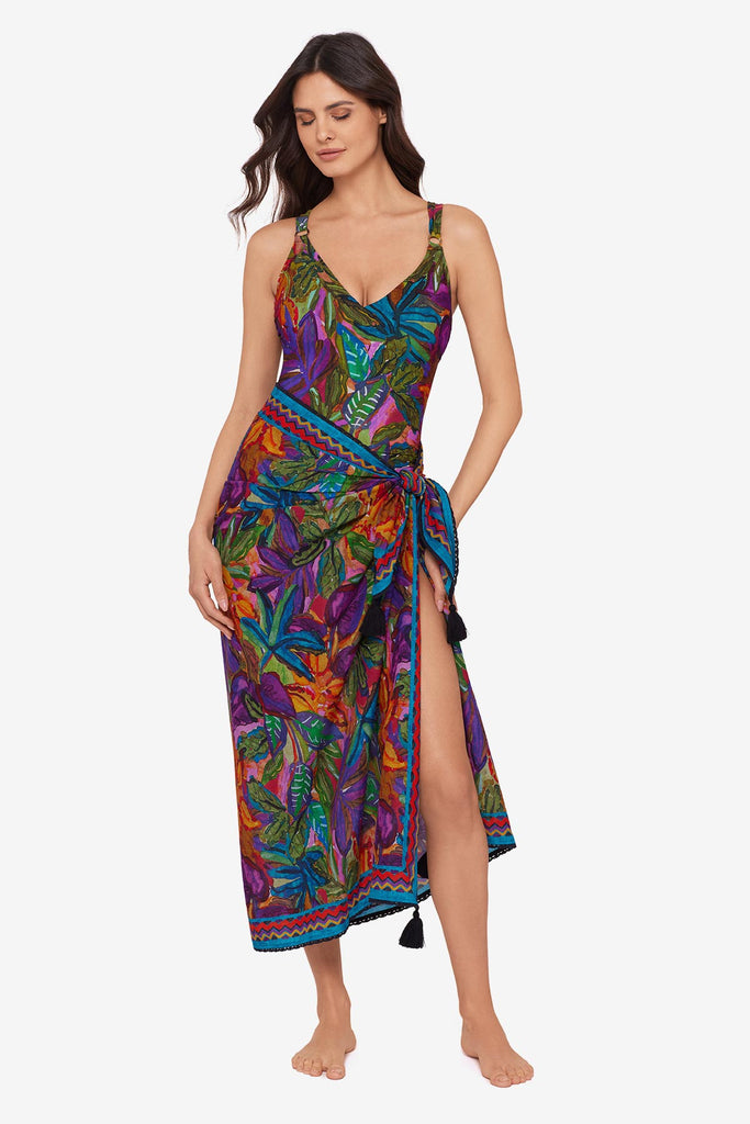 Woman wearing a jungle printed one-piece swimsuit with a matching swim cover up