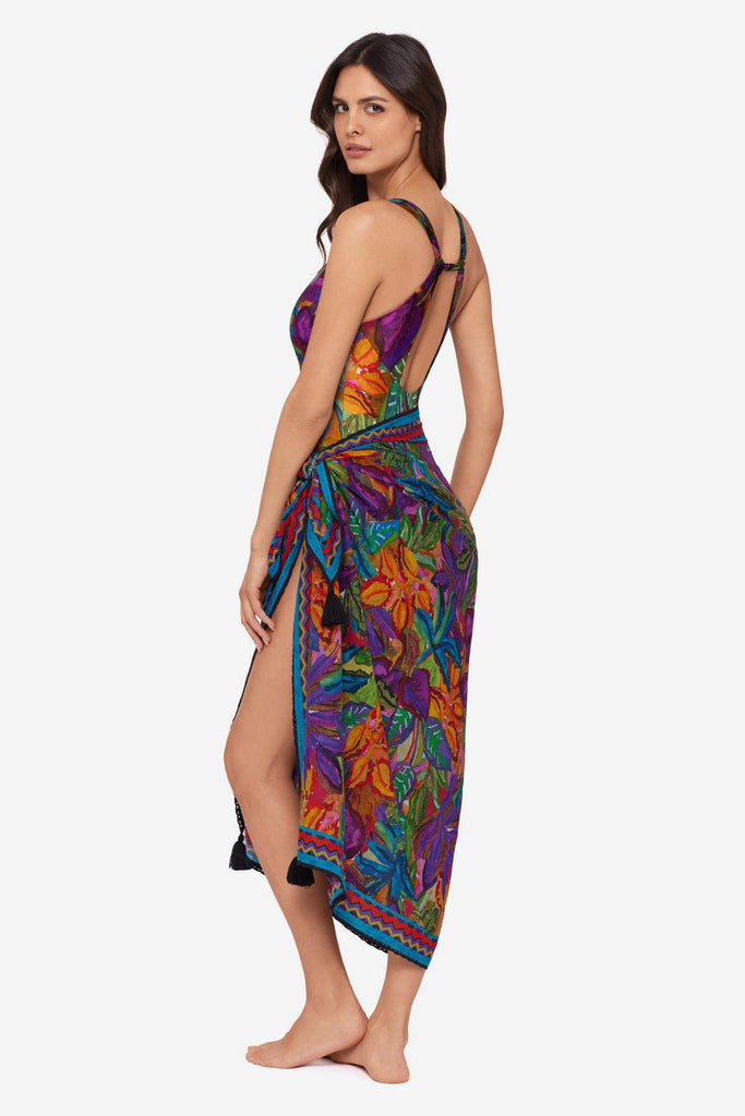 Woman turned left wearing a jungle printed one-piece swimsuit with a matching swim cover up