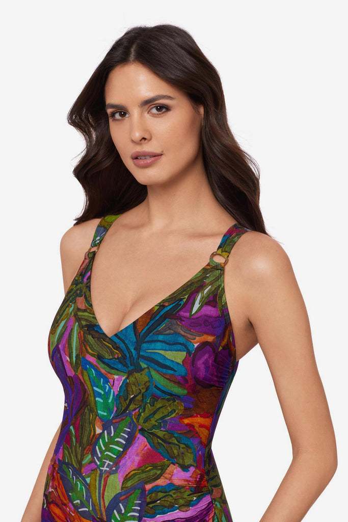 Woman close up wearing a multicolored jungle printed one-piece swimsuit with O ring straps