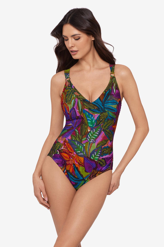 Woman wearing a multicolored jungle printed one-piece swimsuit with O ring straps