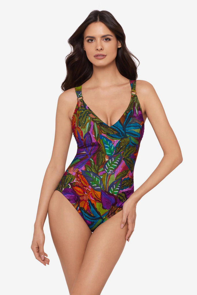 Woman wearing a multicolored jungle printed one-piece swimsuit with O ring straps