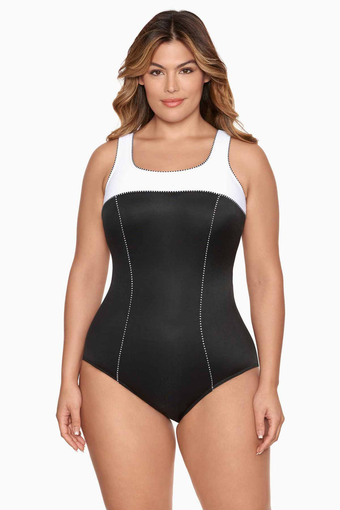 Woman looking stylish in a one piece swim suit.