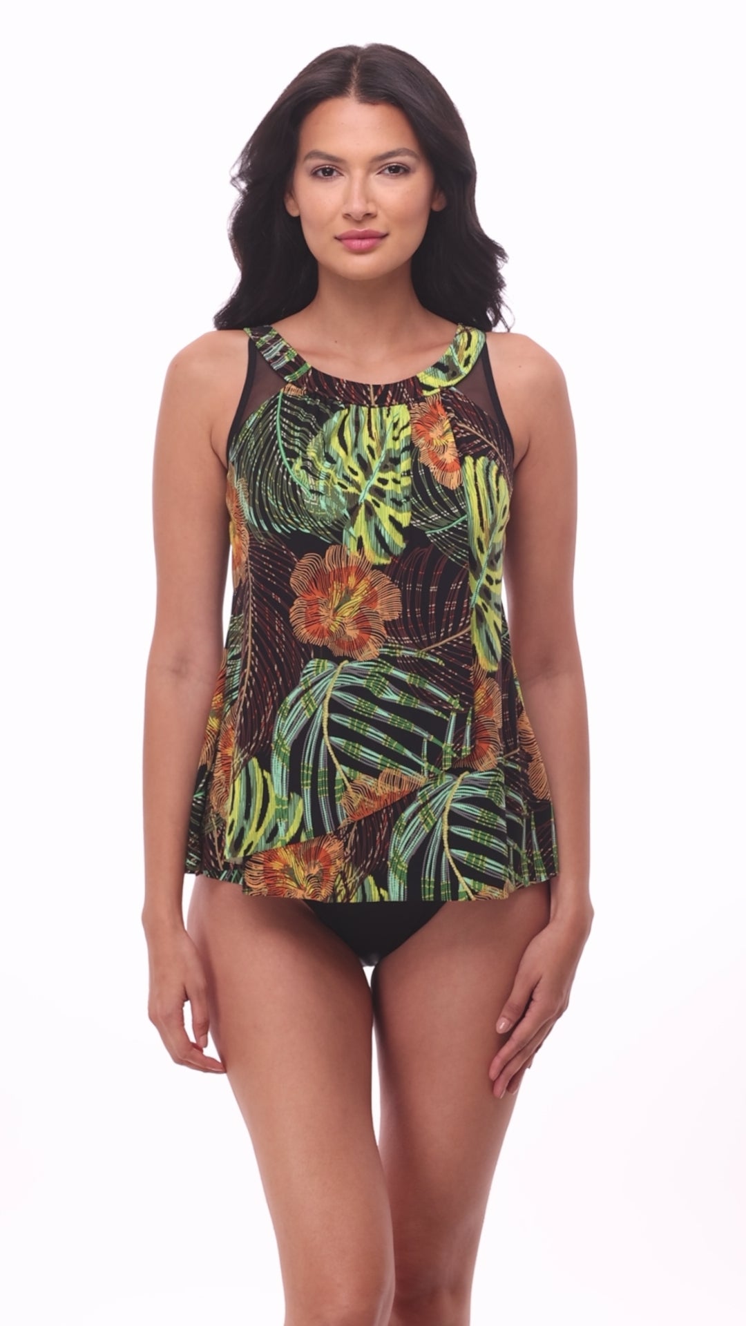 Woman wearing a multicolored palm leaf printed tankini top