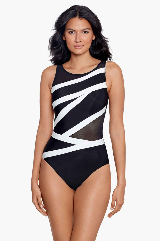 Woman in a black one piece swim suit with white printed strips.